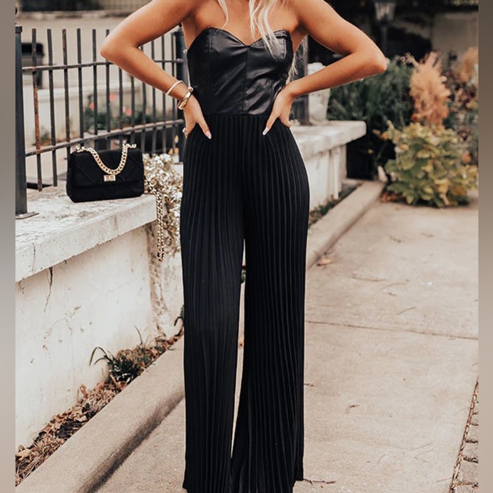 Black jumpsuit, pleated pants and leather top.  One piece